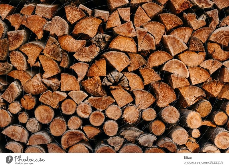 Stacked logs as firewood Logs stacked Wood Firewood Brown Wood chopping Stack of wood background texture