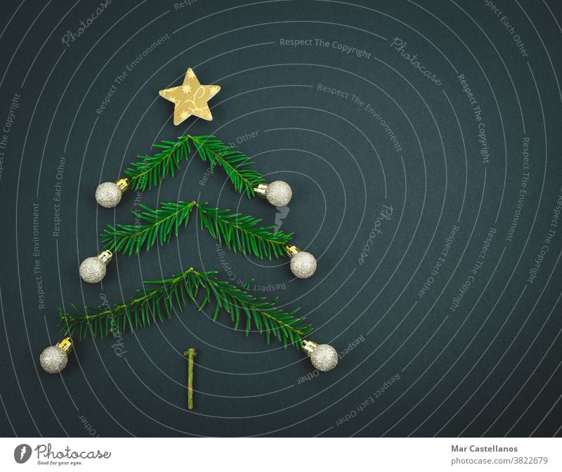 Christmas tree made with pine branches on a black background. decoration christmas end of the year star balls space copy christmas tree decorations concept