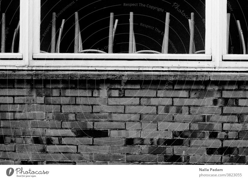 High chairs Analogue photo Black & white photo stones Stone Wall (building) Windowsill Window frame chair legs forsake sb./sth. Exterior shot Day Window pane