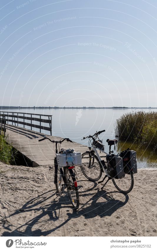 Two bicycles stand at the lake Bicycle Lake Bodden Bodden landscape Mecklenburg-Western Pomerania bike tour Cycling tour Boddenlandscape NP Nature
