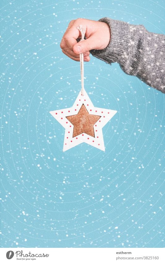 Merry Christmas.Child hand holding a Christmas star. child christmas santa claus fun celebration Christmas present christmas eve snowflakes happiness joy happy