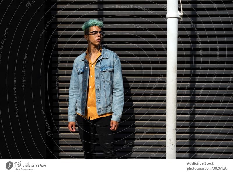 Trendy ethnic man on street in summer hipster blue hair eyeglasses style trendy generation male black african american sunny urban city enjoy young relax guy