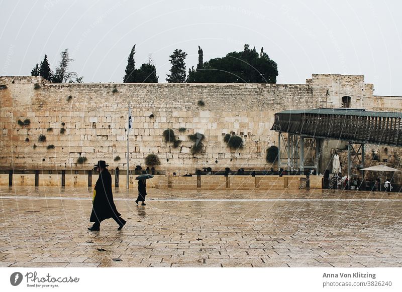 Wailing Wall in the Rain The Wailing wall West Jerusalem Israel orthodox stones Umbrella religion Religion and faith dressed in black religious devout Man