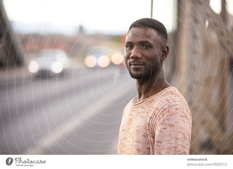 Portrait of Handsome Black Man with Car Traffic Background portrait man black african ethnicity head turned looking away one person one man only 20-30 years old