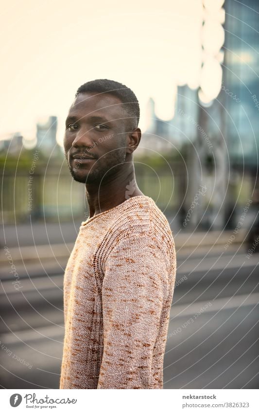 Portrait of Handsome Black Man Turning Head Looking at Camera portrait man black African ethnicity head turned looking at camera one person one man only