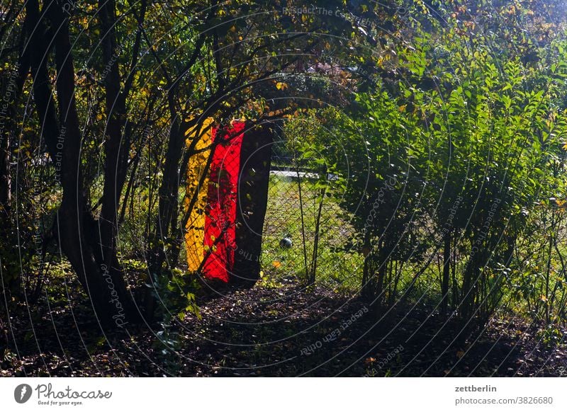 German flag in the allotment garden colony Germany Flag Garden Garden fence Real estate Autumn nationalism Patriotism Fence Garden allotments Wire netting fence