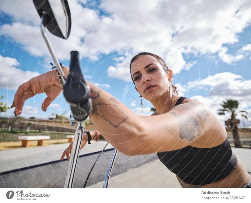 https://www.photocase.com/photos/3828147-serious-woman-on-bike-in-skate-park-bmx-confident-photocase-stock-photo-large.jpeg
