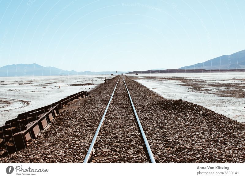 rails Railway rail wide no people no persons Far-off places rail bed no clouds Landscape Outdoors travel Sky Empty nobody Transport Right ahead mountains Ice