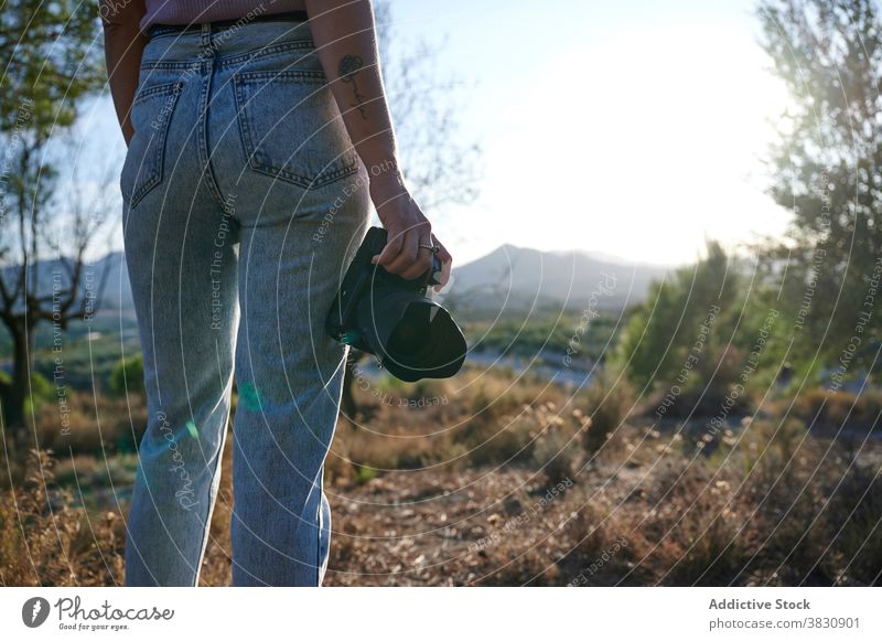 Woman with photo camera exploring nature from hill woman forest mountain autumn traveler hiker photographer female adventure journey countryside tourism