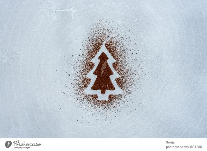 A Christmas tree made of cocoa powder on a grey background. Top view. Draw Creativity Creative concept Art Leisure and hobbies plan Painting (action, artwork)