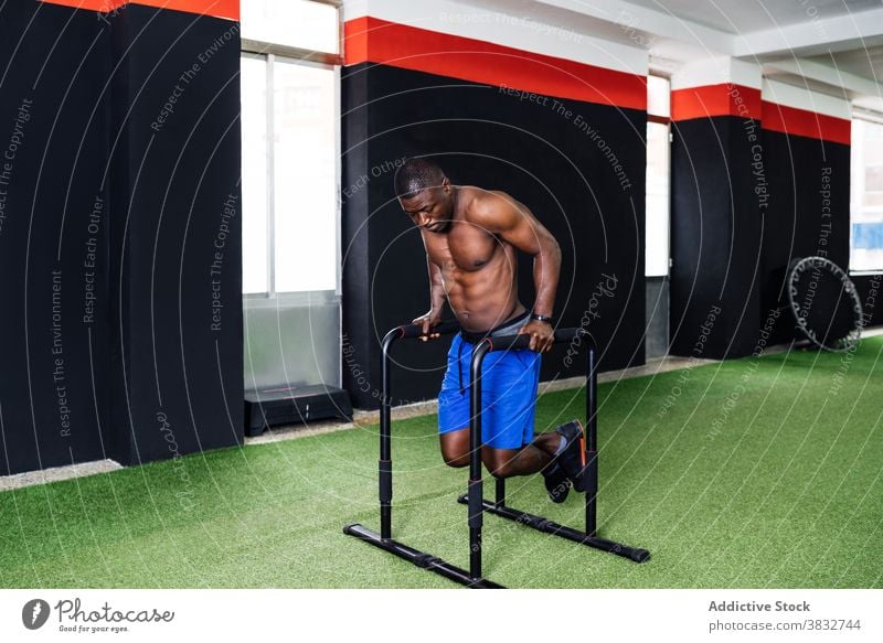 Strong ethnic sportswoman training on exercise machine in modern gym - a  Royalty Free Stock Photo from Photocase