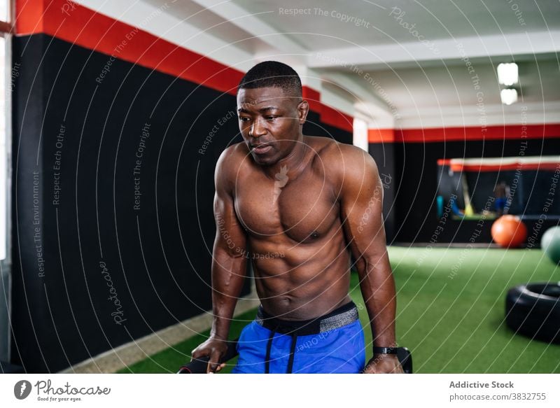 Muscular black man doing triceps exercises on bars gym sportsman parallel athlete workout training functional male ethnic african american power strong muscular