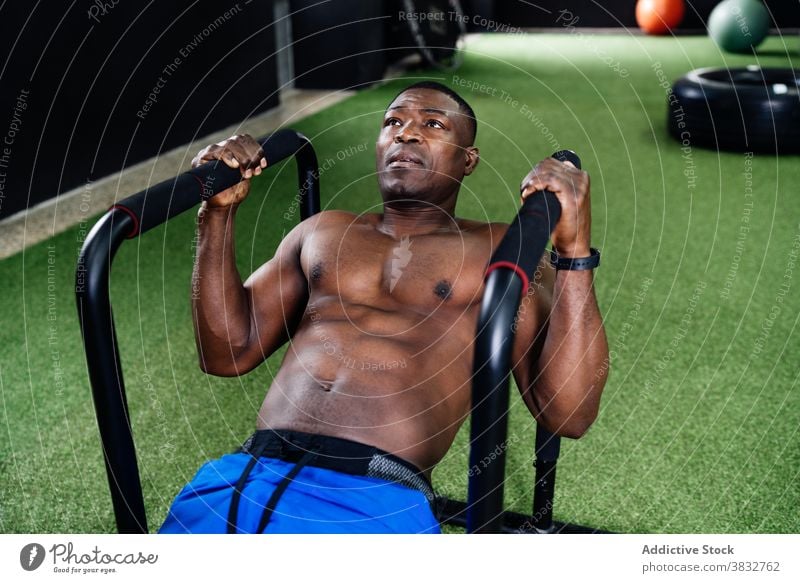 Black man doing exercises on parallel bars a Royalty Free Stock