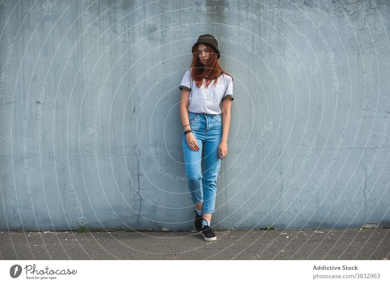 Hipster young woman in hat standing near wall hipster trendy millennial urban style student casual teen red hair redhead female outfit fashion lifestyle teenage