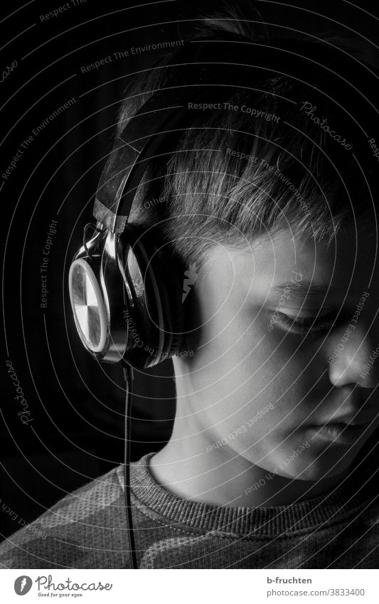 Child with headphones Headphones Music Listen to music Listening portrait Lifestyle Black & white photo Boy (child) To enjoy black-and-white