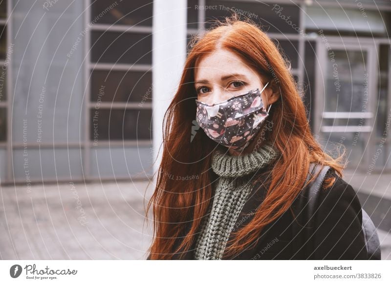 young woman wearing everyday cloth face mask outdoors in city everyday mask community mask real people lifestyle corona winter coronavirus covid covid-19
