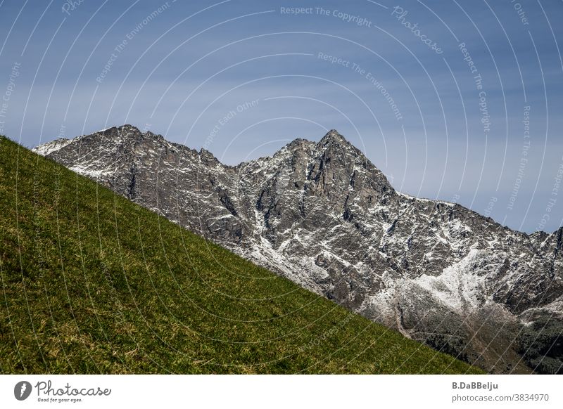 The Alps rise up behind the green mountain meadow. Italy South Tyrol Peak Landscape Mountain Sky Hiking Climbing Rock Mountaineering Vacation & Travel