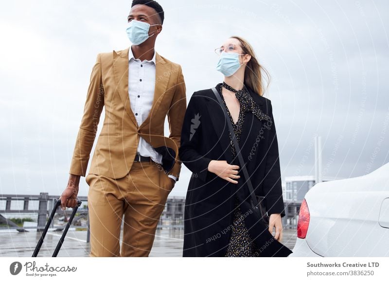 Business Couple Wearing Masks Outside Airport For Business Trip With Luggage During Health Pandemic business businessman businesswoman face mask face covering
