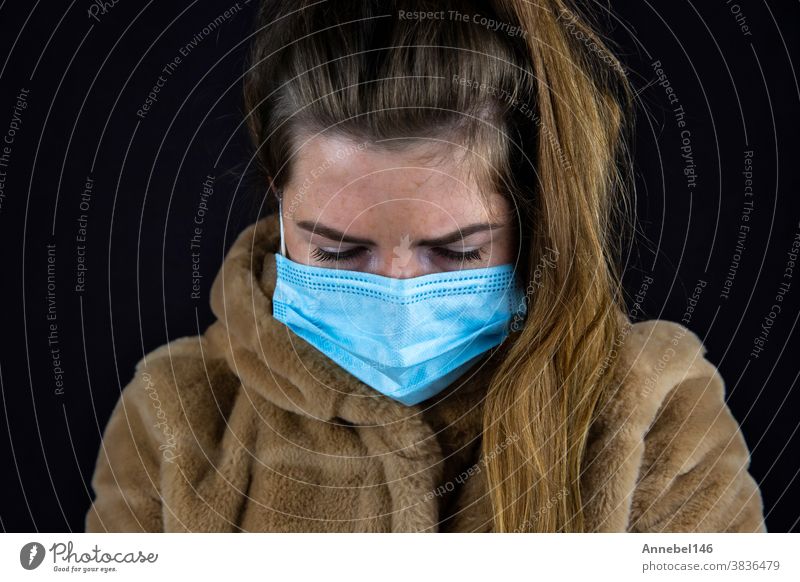 Portrait of a beautiful young woman wearing a winter jacket with medical mask for Coronavirus, Covid-19 concept person face portrait people girl lady female