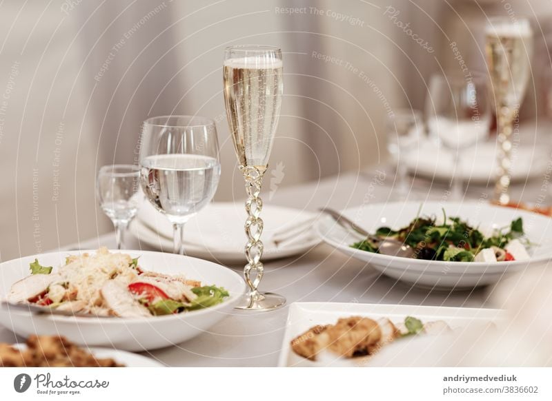 Serving table of a variety of delicious festive food and wine prepared for event party or wedding. selective focus. dinner setting celebration dining nobody