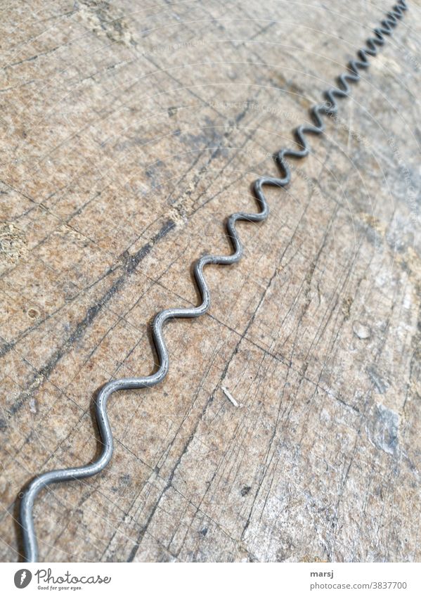 Wavy iron wire on wooden table Steel Wire crimped Wood lacerated Stainless Stainless steel Diagonal passing Old Metal