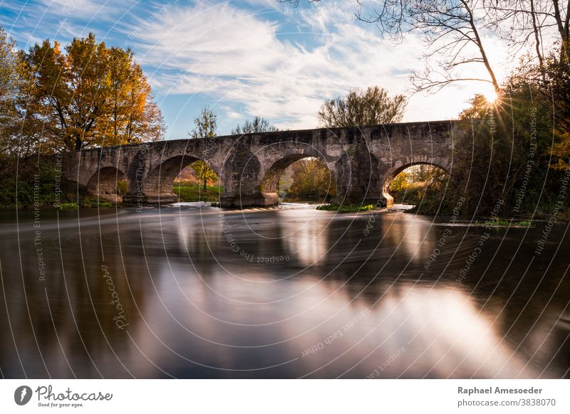 Bridge over river Altmühl lighten up in autumn mood, long exposure altmuehl architecture beautiful bridge building clouds color colorful countryside day europe