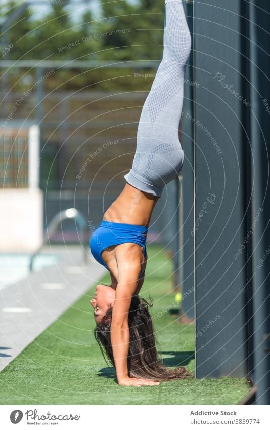 Slim woman doing handstand during training - a Royalty Free Stock Photo  from Photocase