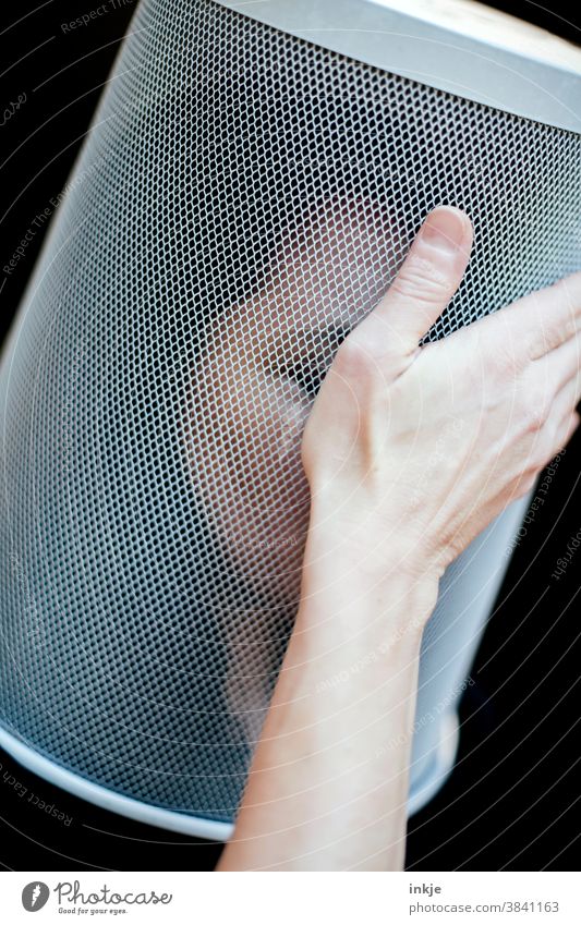 Portrait of a woman with wastepaper basket over her head and hand on her forehead Colour photo Interior shot Close-up portrait 1 portrait of a woman