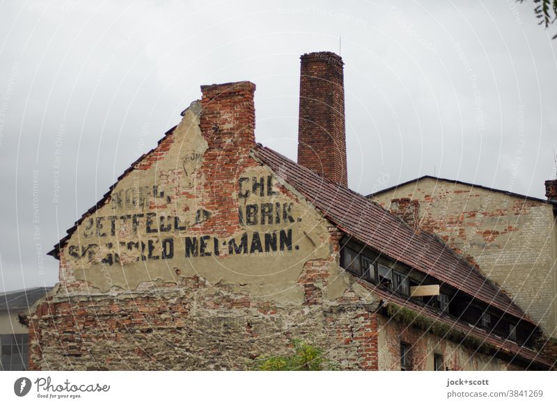 View of an old dilapidated factory Building Factory Fire wall Architecture Sky Derelict Facade Old Chimney lost places Ruin Past Lettering Advertising