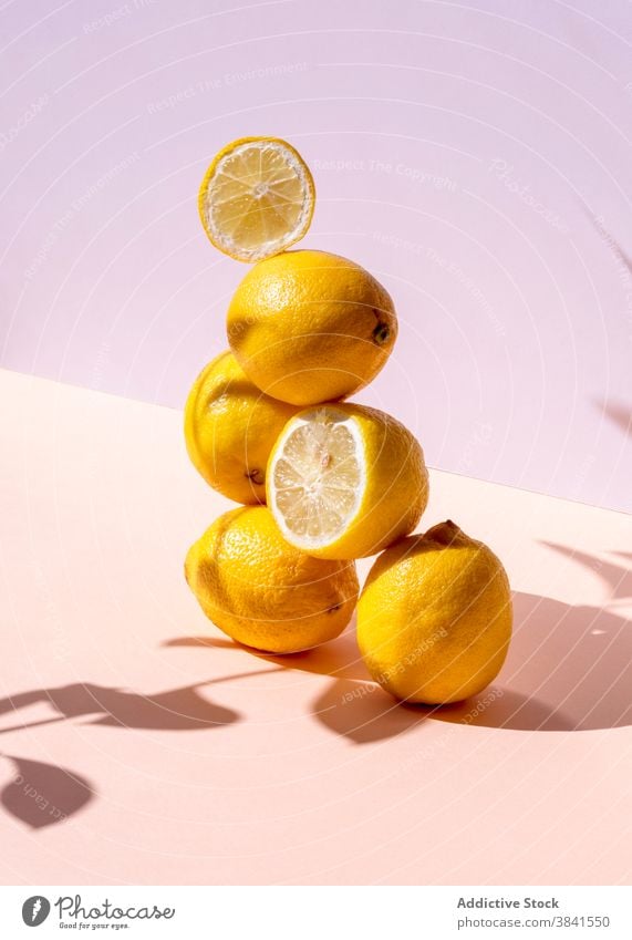 Pile of lemons arranged in studio creative stack composition art fresh sour pile balance pyramid shape natural healthy organic yellow color shadow shade