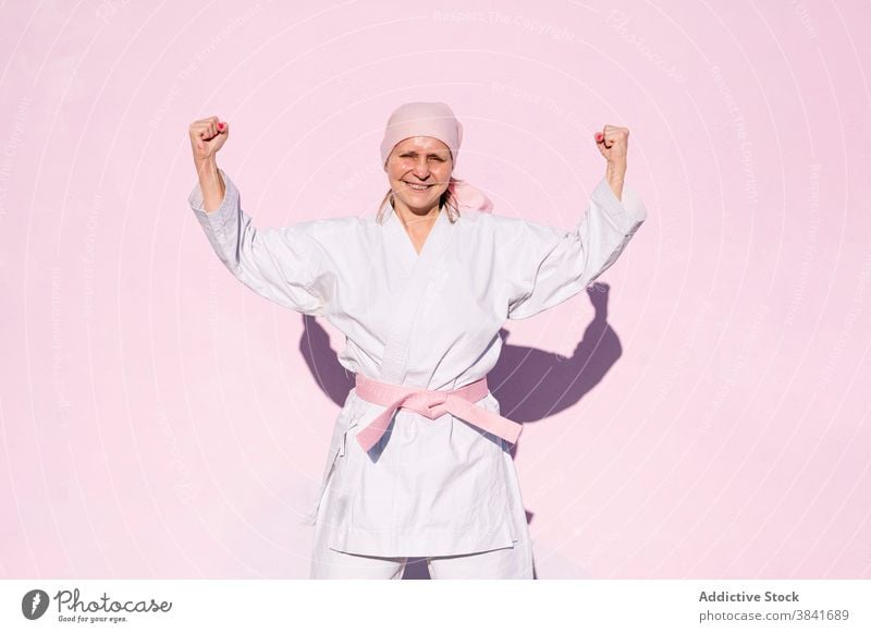 Karate woman who has defeated cancer karate martial sport campaign awareness health female fighter pink foulard confident disease cheerful remission strong