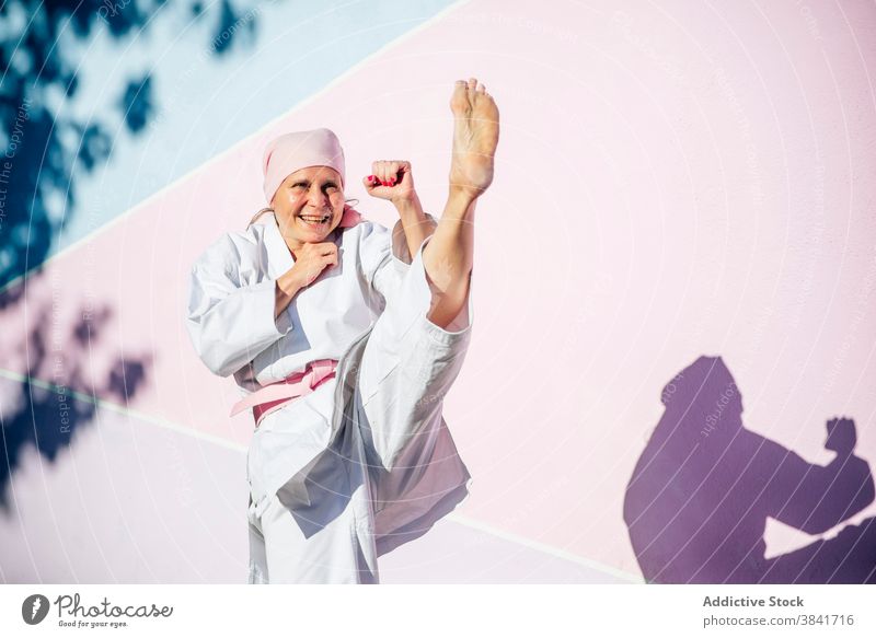 Karate woman who has defeated cancer karate martial sport campaign awareness health female fighter pink confident disease remission strong oncology recovery