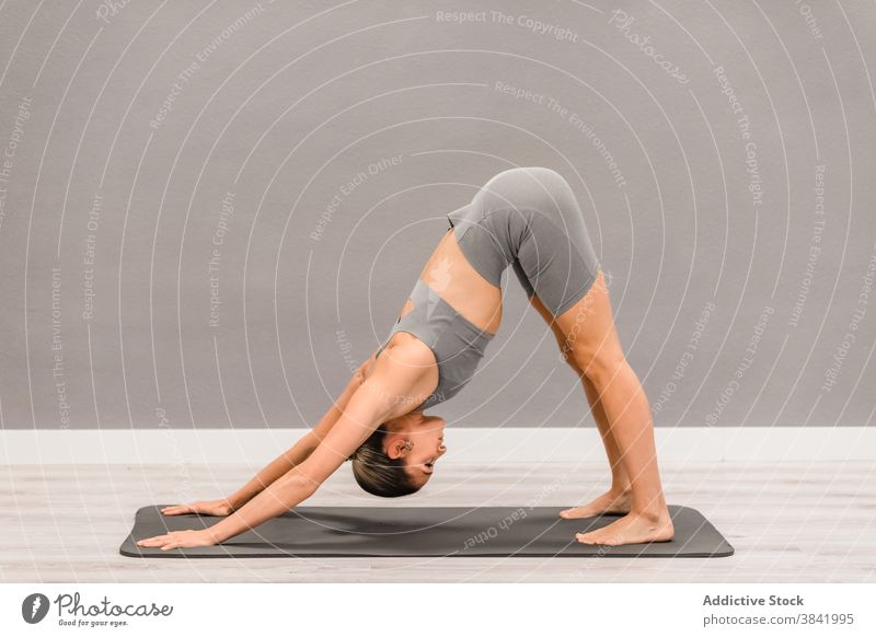 Woman practicing yoga in studio - a Royalty Free Stock Photo from Photocase