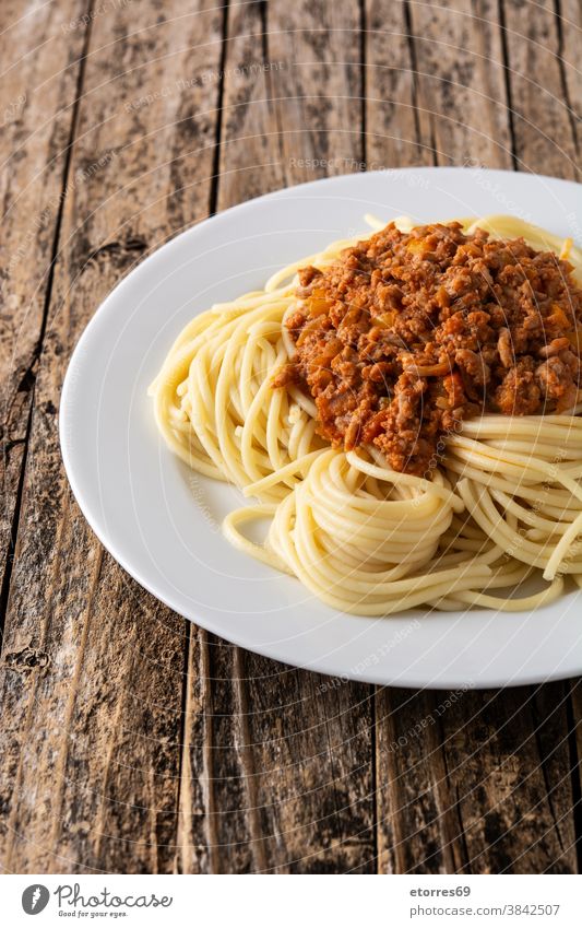 Spaghetti with bolognese sauce on wooden table spaghetti beef cheese food pasta cuisine italian dinner dish homemade italy meat parmesan plate recipe served
