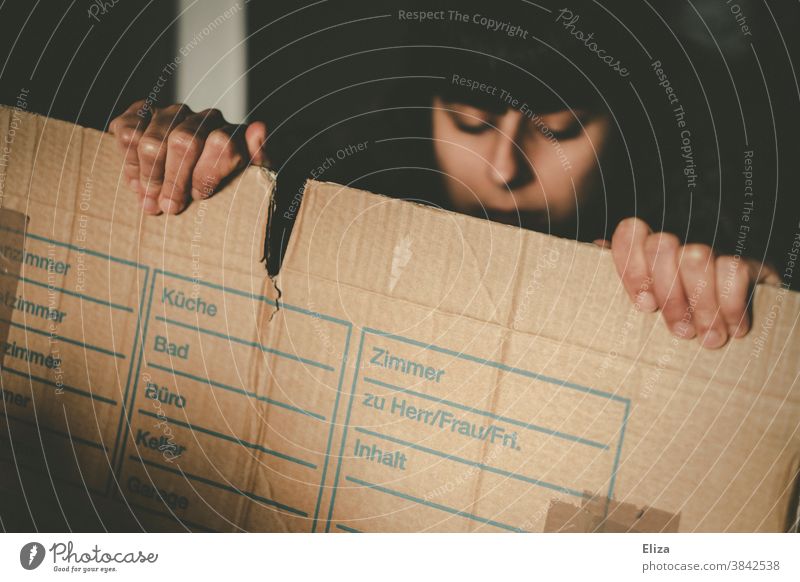 A woman holding a moving box. relocation Packing case Grasp Package change of flat Packaging material Crate move out tidy out Box up Cardboard Dark tired