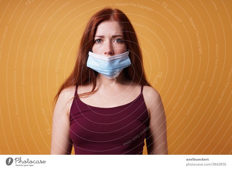 young woman who is wearing a mask under her nose in the wrong way corona Mask False Nose Corona deniers Face mask Corona Refusers COVID coronavirus deny Denier