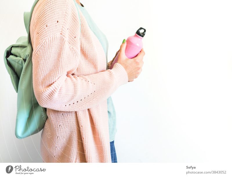 Woman in pastel with backpack and reusable bottle pink water woman lifestyle zero waste drink fashion eco refill free concept hipster bag thermo people hand