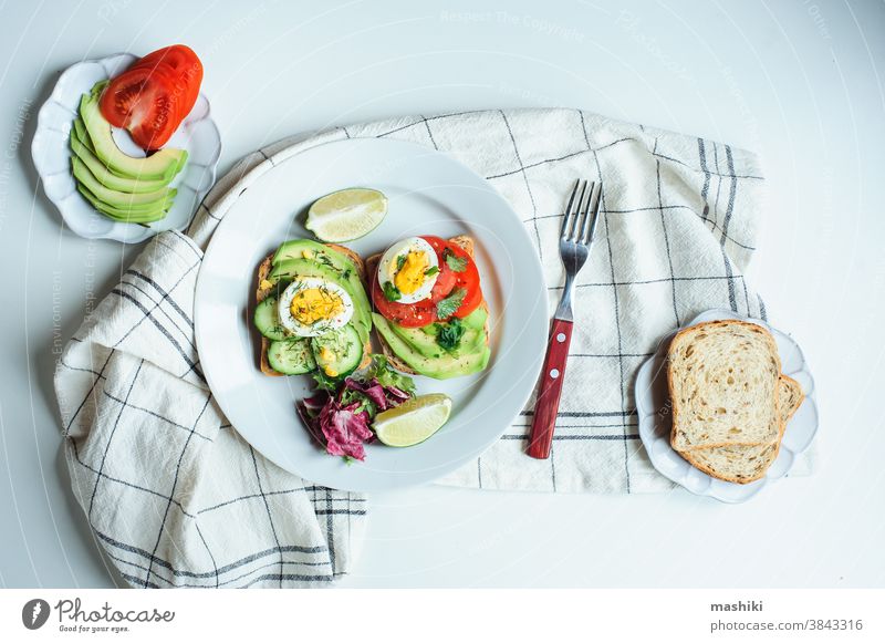 healthy vegetarian breakfast, avocado toast with cucumber, eggs, tomato and greean salad on wholegrain bread meal food lunch green sandwich diet fresh snack