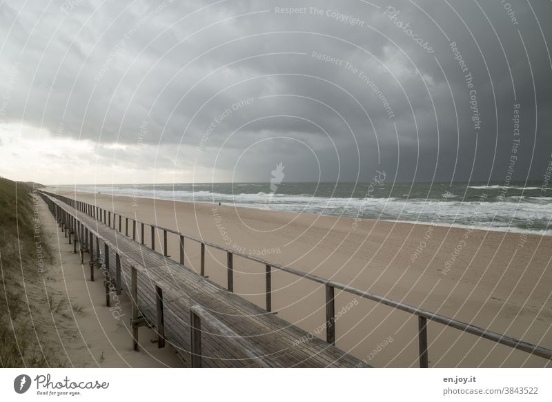 Wooden jetty on the beach of Westerland before approaching storm wooden walkway Beach Ocean North Sea Sylt Empty Gale Weather Bad weather Rain