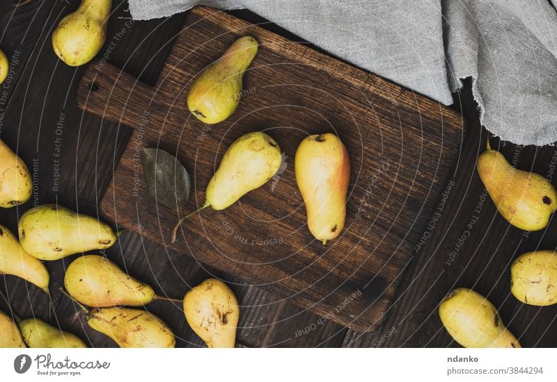 ripe yellow pears on brown wooden cutting board raw rustic season sweet table tasty vegetarian vintage vitamin above agriculture autumn background closeup food