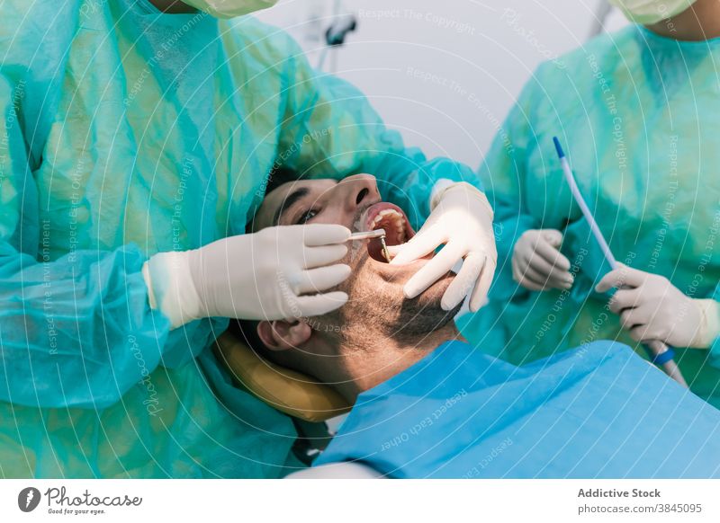 Dentist testing a splint in the clinic on his patient tooth dentist implant denture medicine crown dental dentistry doctor oral medical treatment hospital