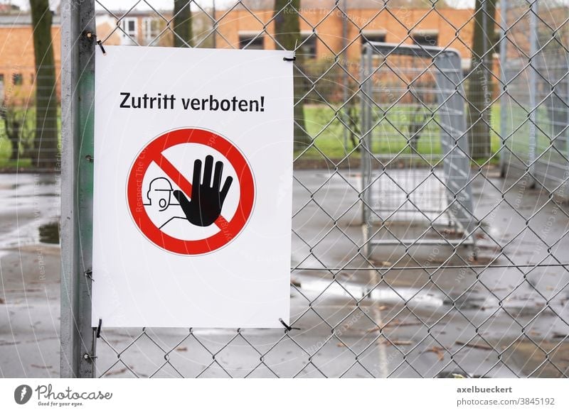 Closed sports ground with prohibition sign Zutritt verboten - meaning no entry in German zutritt verboten closed germany corona fence football soccer closure