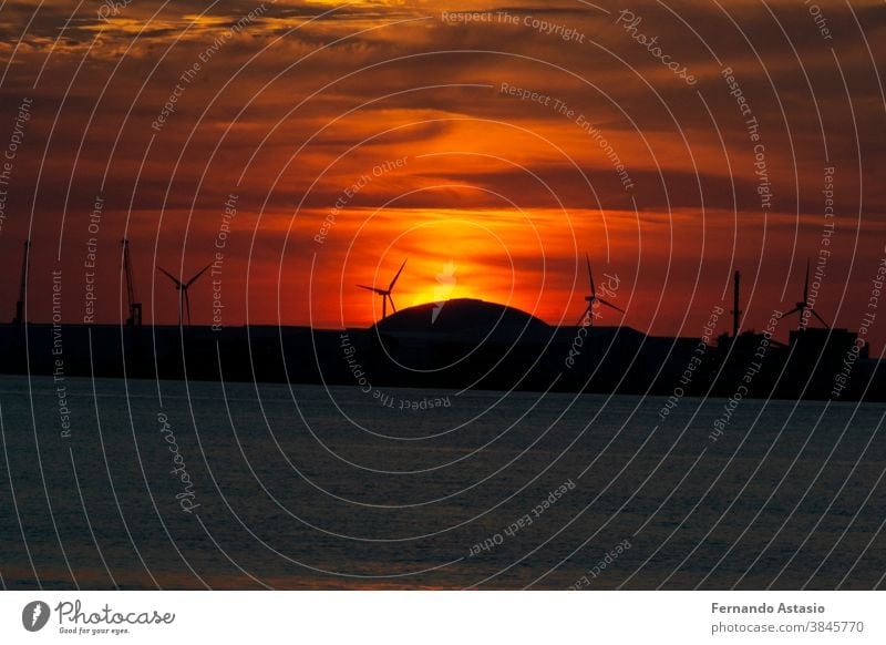 Sunset with orange color in the sky at Getxo-Guecho beach. Spanish municipality located on the coast of the Cantabrian Sea, in the province of Vizcaya, in the Basque Country