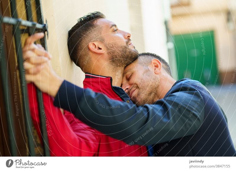 Gay couple in a romantic moment outdoors gay laugh laughing male love homosexual lgbt lgbtq relationship lovers boyfriend people adult happy outside together