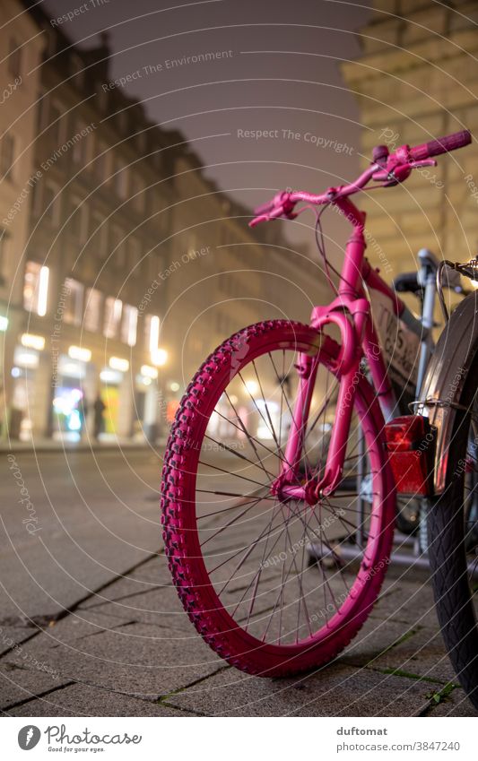 Pink bike parked on street at night and fog Wheel Bicycle pink Tire Road traffic Means of transport Detail Deserted Close-up Parking Profile Munich
