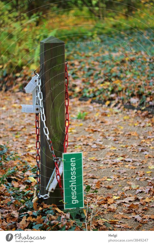 not yet - sign "closed" hangs on a red-white chain next to a wooden pole, the path is still accessible Prohibition sign Signage Closed stake Chain cordon open