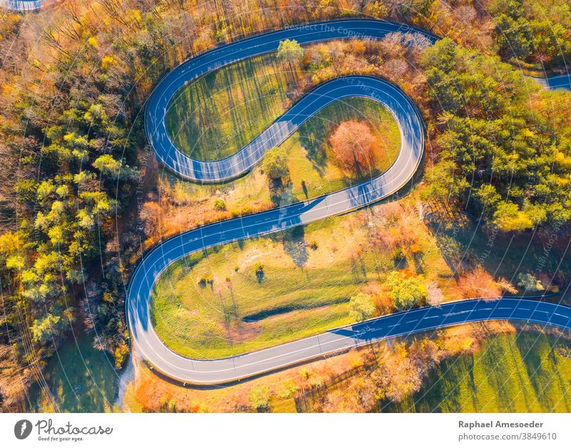 Curvy road up the mountain, aerial view on autumn evening above architecture asphalt color colorful colors construction curve curvy destination drive fall