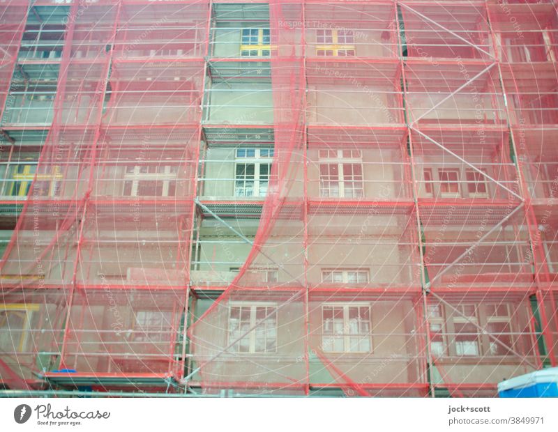 Greener living, construction site with reddish scaffolding Facade Construction site Scaffold Covers (Construction) Protection Authentic Structures and shapes