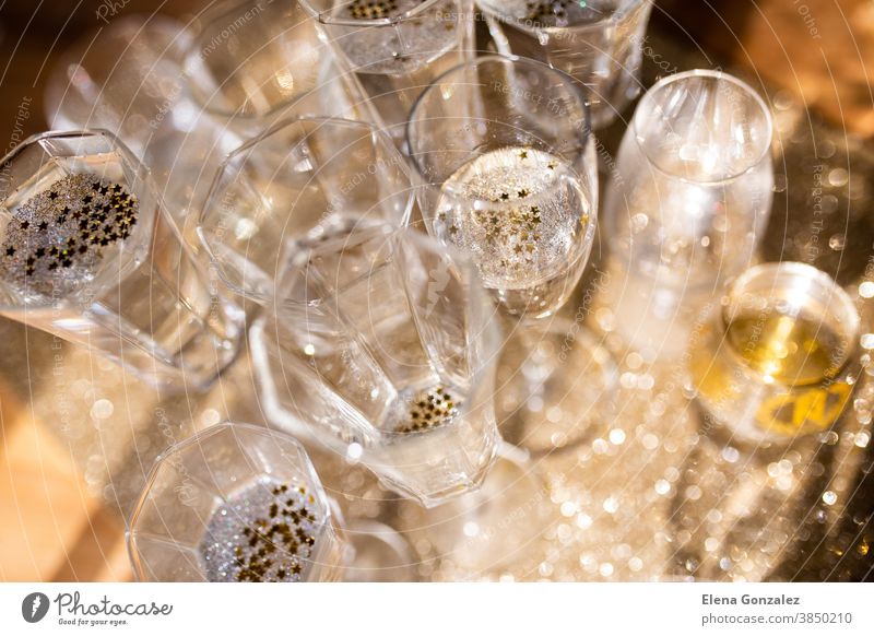 Several champagne glasses over gold christmas background. Celebrating new year concept. merry christmas lights sparkle greetings congratulations years ornaments