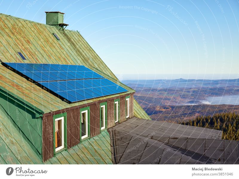 Solar panels on an a roof of an old mountain shelter. solar nature power renewable energy green technology solar panels photovoltaic ecology installation